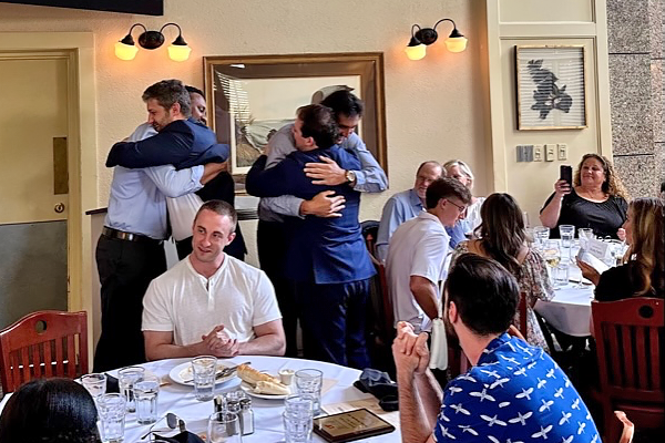 Residents faculty hugging at graduation