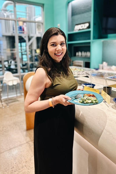 Faculty member indoors holding a plate of food