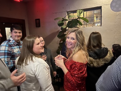 Group of faculty talking at the holiday party