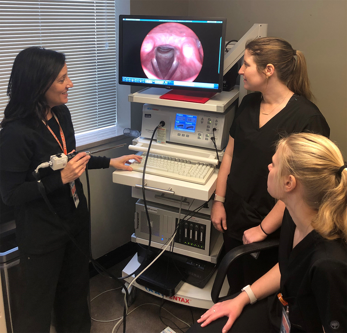 Kim Almand with two students working with the strobe machine.