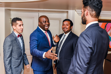 Program director shaking hand of fellow at ceremony