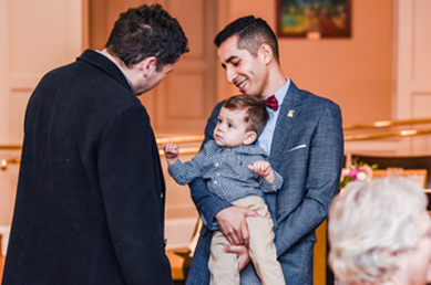 Two males residents, one holding a young child