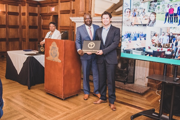 Graduate receiving an award from faculty member