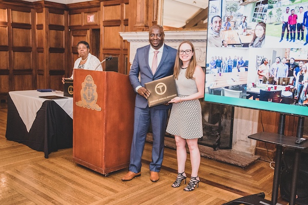 Graduate receiving an award from faculty member