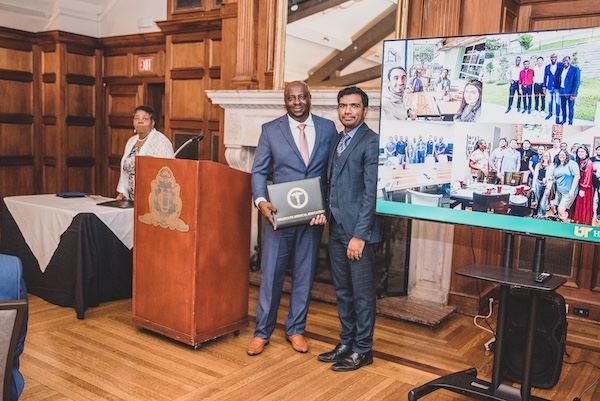 Graduate receiving an award from faculty member