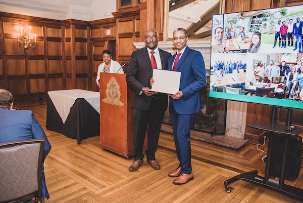 Graduate receiving an award from faculty member