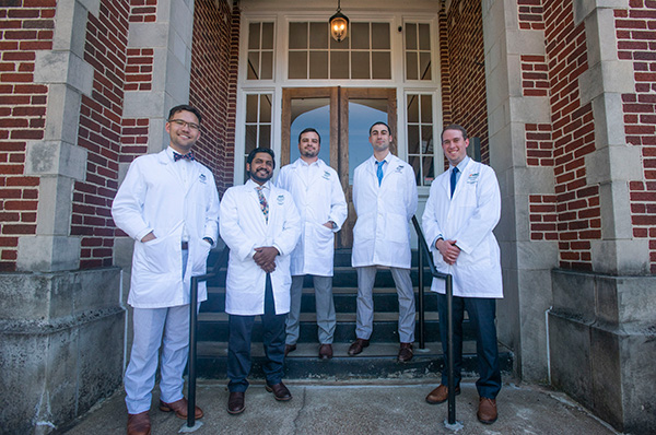 Resident Group together in front of building. View text below for list of residents.