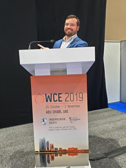 Matthew Watson, DO, at a podijm at the World Congress of Endourology.