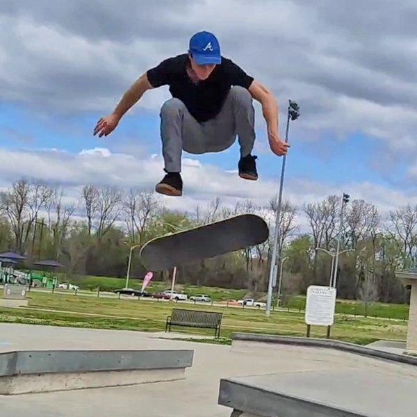 Male resident jumping a skateboard outdoors