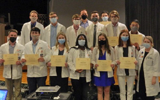 Graduates holding certificates