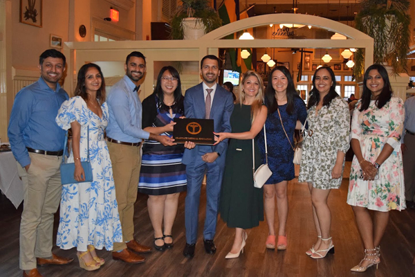 Group photo of fellows, faculty, and family at graduation