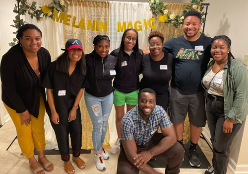 Group of ABRM residents taken in front of curtains