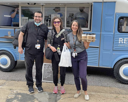 Residents getting coffee from a food truck