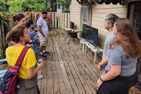 Residents outside, talking on a deck