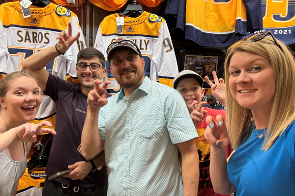 Residents inside a Nashville Predators giftshop with hockey jerseys in the background