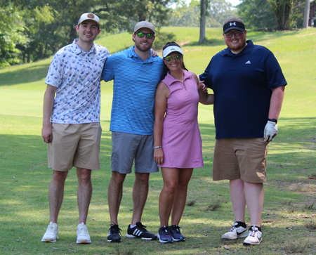 Three male residents and a female resident on the golf course