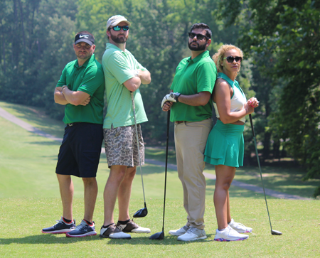 Three male residents and a female resident on the golf course