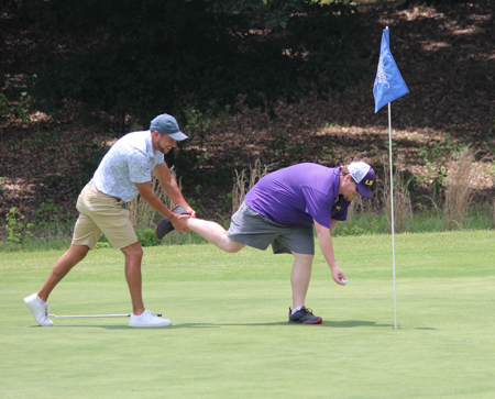 Resident grabbing another's foot on the golf course