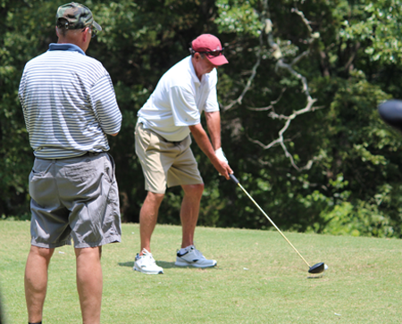 Faculty member about to tee off on the golf course