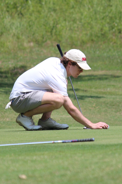 Resident lining up his golf ball on the golf course