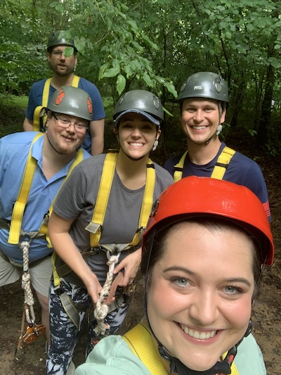 Resident outdoors with ziplining gear on