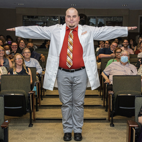 Resident walking the aisle at graduatoin