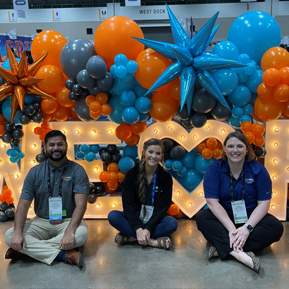 Residents in front of balloons and letters