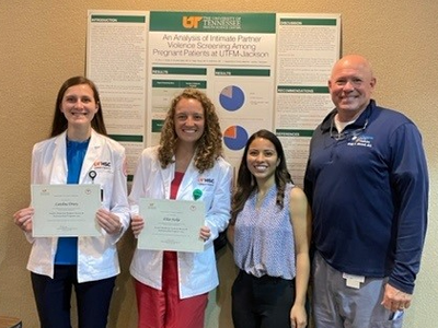 Residents and Dr. Mitchell before a research presentation