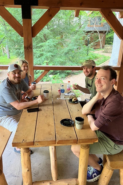 residents sitting outside at a picnic table