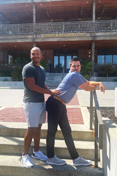 Male faculty members standing outside on stairs