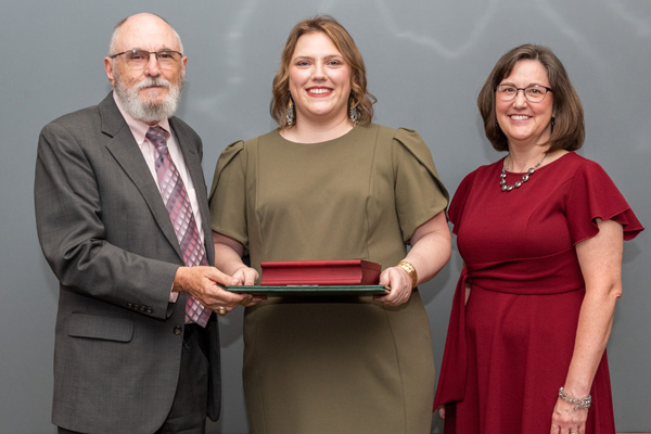 Faculty presenting resident with certificates