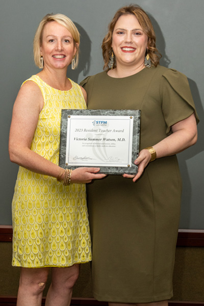 Faculty and resident with award