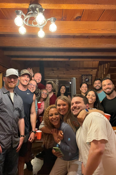 Group photo of residents in a wooden indoor room