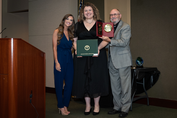 Faculty members with resident holding an award