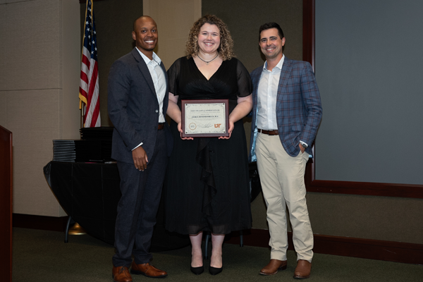 Faculty members with resident holding an award