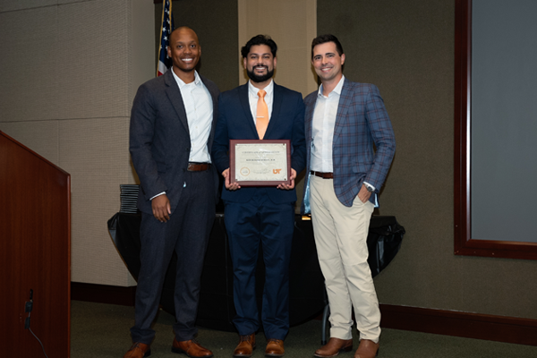 Faculty members with resident holding an award