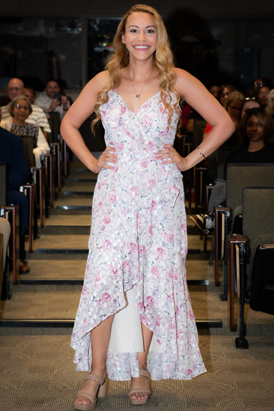 Female resident walking the aisle at graduation