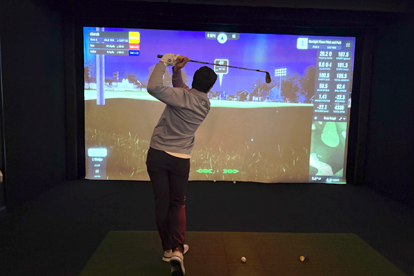 Residents playing virtual golf indoors