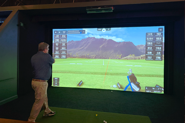 Residents playing virtual golf indoors