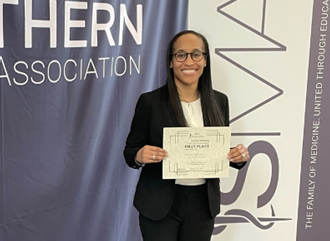 Dr. Hardy holding a certificate