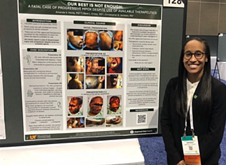 Dr. Hardy standing in front of her presentation poster