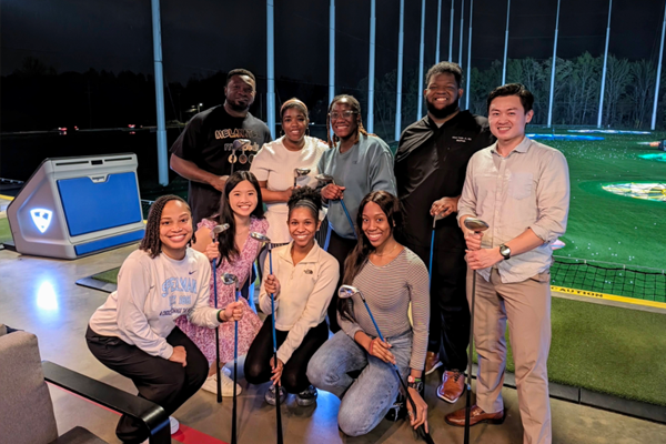 Residents outside at a golf driving range