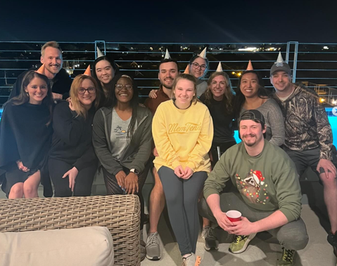 Residents sitting on a building rooftop at night