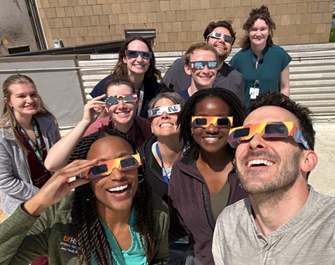 Residents outside with eclipse glasses on