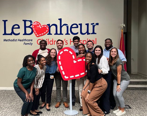 Residents in a Le Bonheur hallway posing by the heart statue