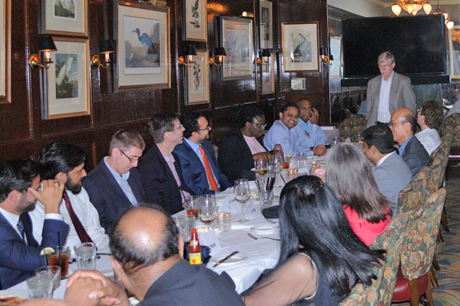 Dr. Wall addressing the table of fellows, faculty, and guests.