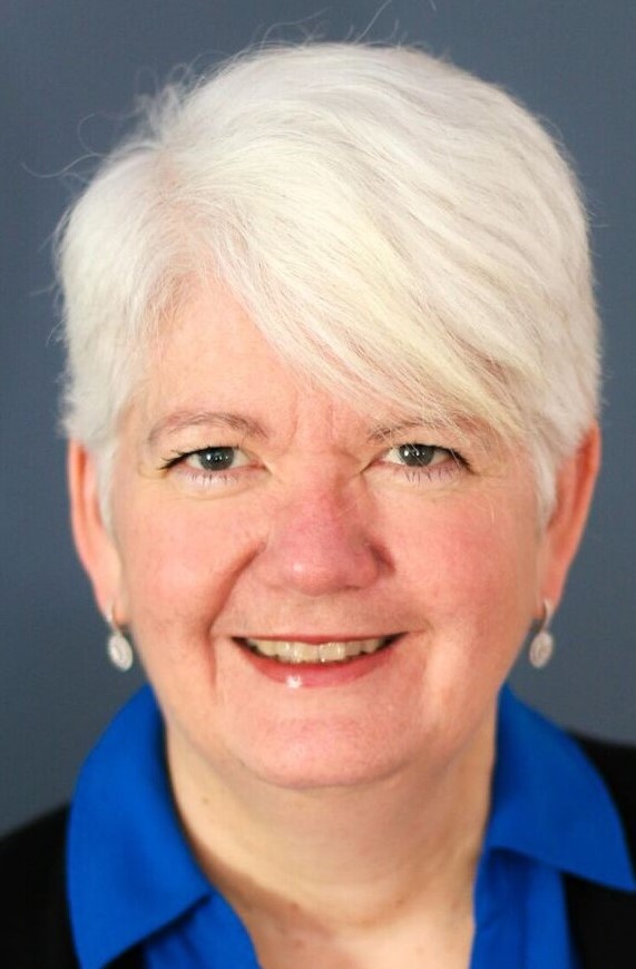 Woman with white hair and blue shirt