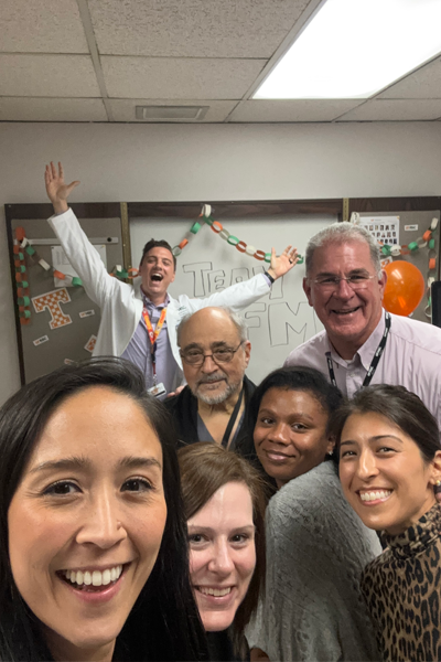 Group photo of fellows and faculty in an office