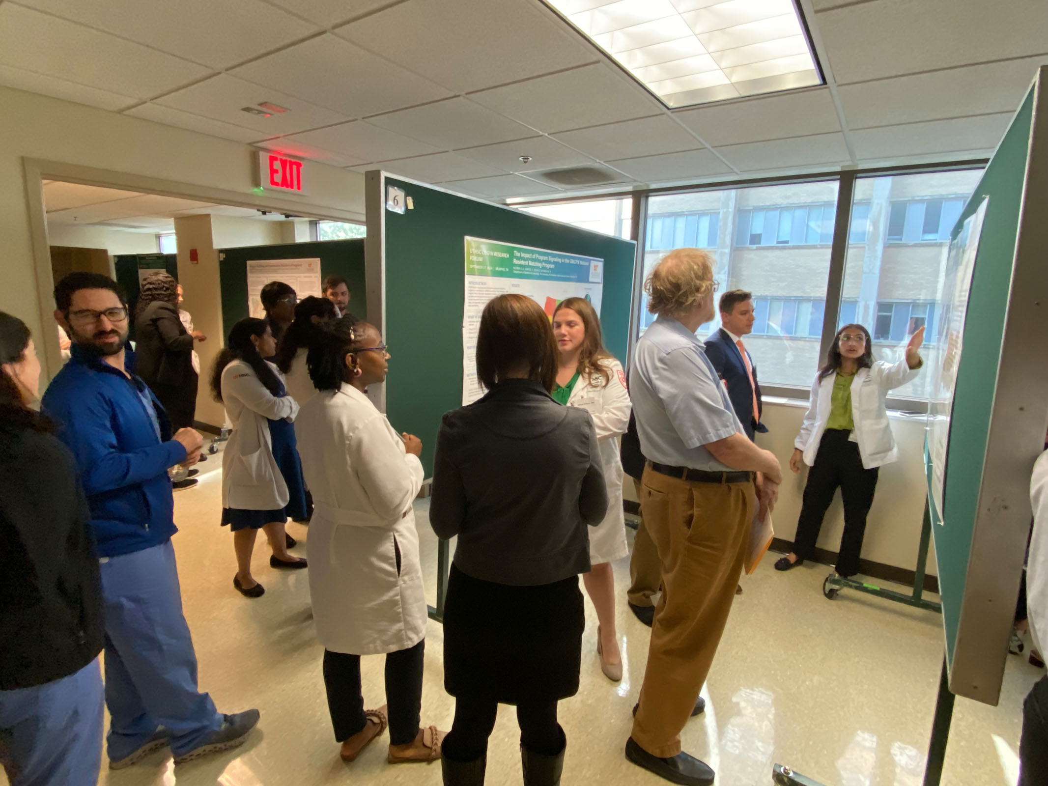 Faculty and students exploring presentation boards at the 2024 Research Forum.