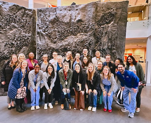 Group photo in front of climbing wall